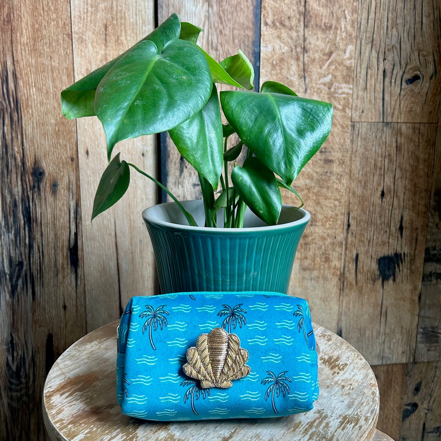 Teal palm tree makeup bag with a detachable Shell brooch